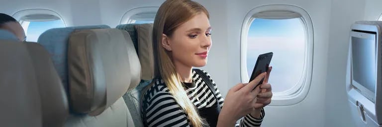 woman-using-onboard-wifi-on-phone-w768x256
